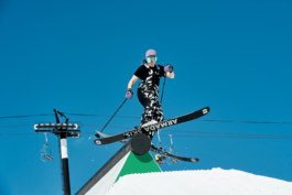 Park skier, on the rail, with chairlift in the background. Ross Woodhall - Action & Lifestyle Photography