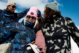 Four skiers being playful in their poses in front of the camera. Ross Woodhall - Action & Lifestyle Photography