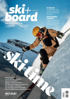Front cover of Ski + Board magazine with close up of skier off piste with blue sky and mountain in background. Ross Woodhall - Action & Lifestyle Photography