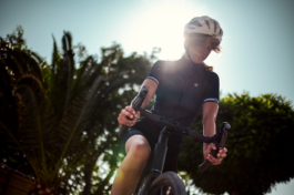 Woman wearing cycling clothes and a bike helmet on a road bike. Ready to go. Ross Woodhall - Action & Lifestyle Photography