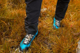picture of hiking shoes with dirt on in the rough grass. Ross Woodhall - Action & Lifestyle Photography