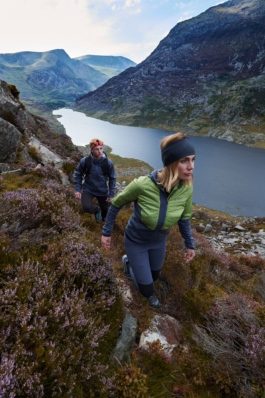 Couple hiking between the heather, above the valley and lake. Ross Woodhall - Action & Lifestyle Photography
