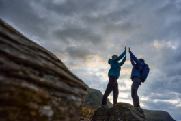 Couple out hiking, doing a double high five. Shot at a low level. Ross Woodhall - Action & Lifestyle Photography