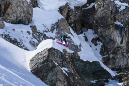snowboarder off piste, jumping off a cliff with right hand in a grab with the board Ross Woodhall - Action & Lifestyle Photography